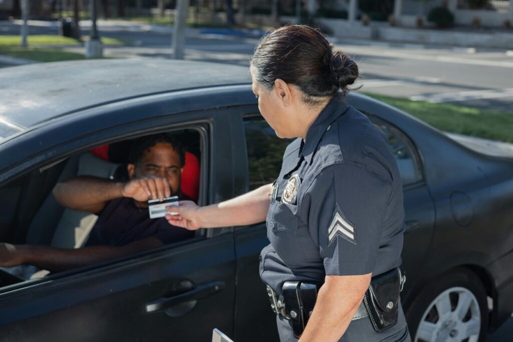 A police officer collecting a driver's license during a traffic stop