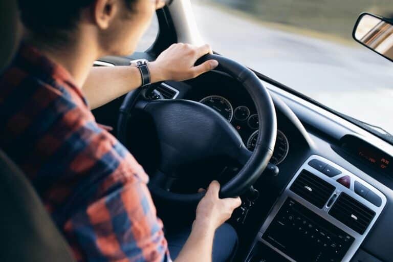 Driver gripping the steering wheel of a car before a traffic stop in Texas
