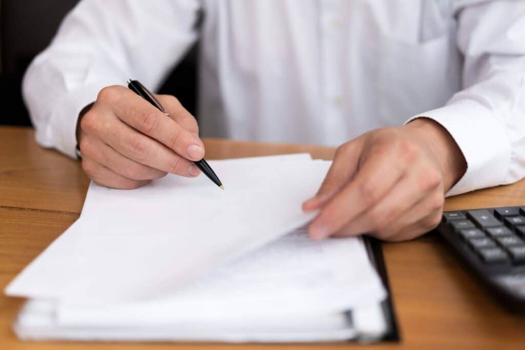 Lawyer explaining ODL paperwork on a brown wooden desk in an office.